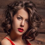 Beautiful lady in red dress pose on wooden background.